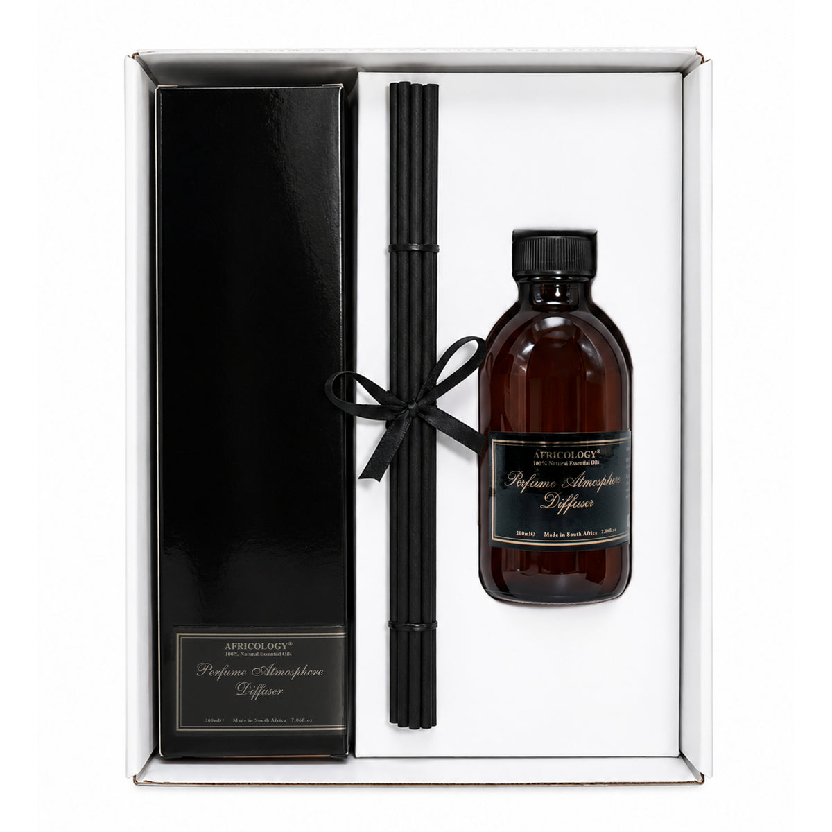 Open Africology gift box with the boxed reed diffuser, ribbon-tied reeds and 200ml refill in the insert