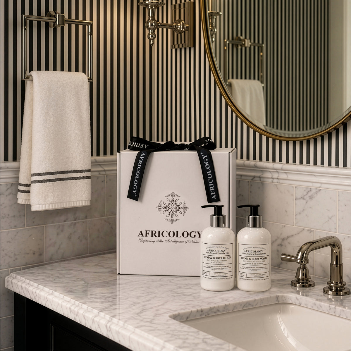 Africology Bio Therapy Wash and Lotion gift box on a marble vanity beside a basin